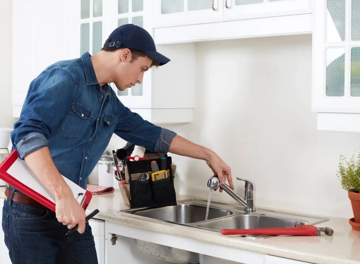 Plumber checking a kitchen sink drain